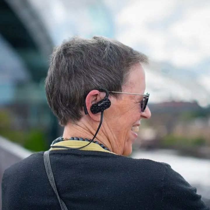 Woman wearing Emotiv headphones